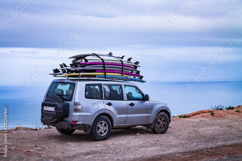 Surfboards mounted on the roof of the car. photo travel. Leisure 