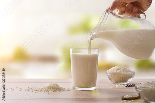 Serving rice drink in a glass in a kitchen