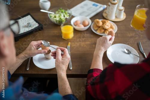 Senior people eating breakfast together