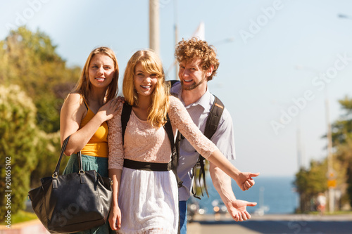People friends hitchhiking on summer vacation.