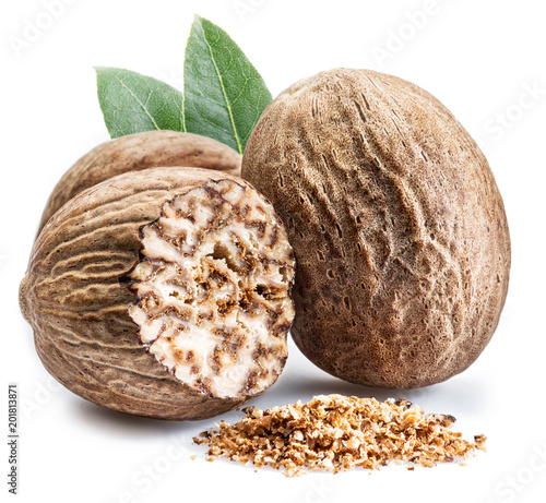 Dried seeds of fragrant nutmeg and grated nutmeg isolated on white background.