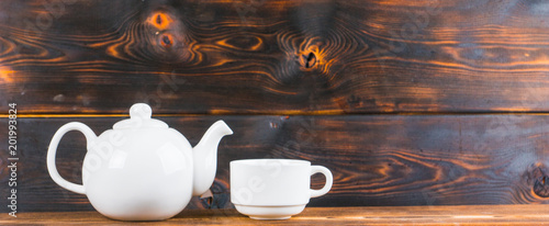 tea cup and pot on rustic wooden table, panoramic shot