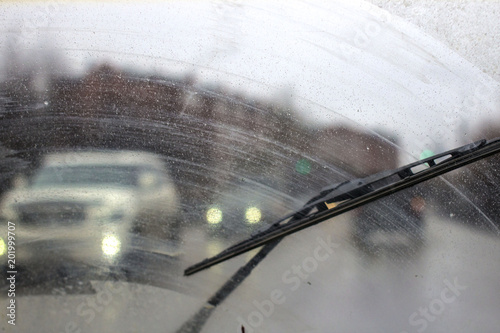 Windshield wipers from inside of car, season rain.