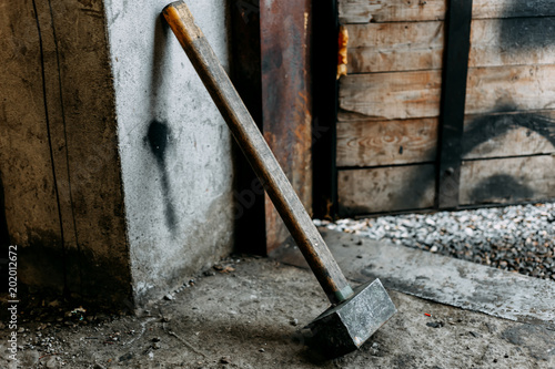 old sledgehammer standing in garage