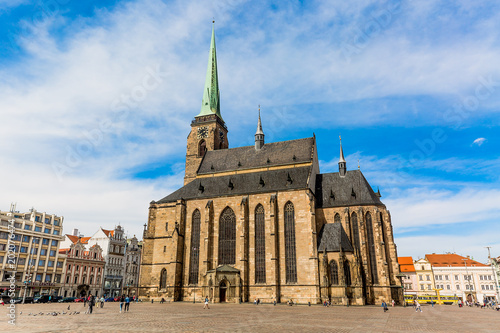 St. Bartholomew's Cathedral in the main square of Plzen with blue sky and clouds in sunny day. Czech Republic, Pilsen. Famous landmark in Czech Republic, Bohemia.