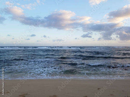 Waves of the ocean waters move towards the beach of Camp Mokuleia Beach