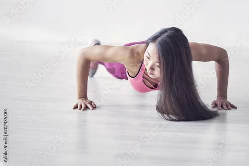 Sporty Asian women exercise indoor at home she is acted "push up". finished jogging