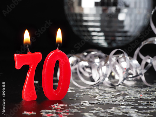 Red candles showing Nr. 70Abstract Background for birthday or anniversary party.