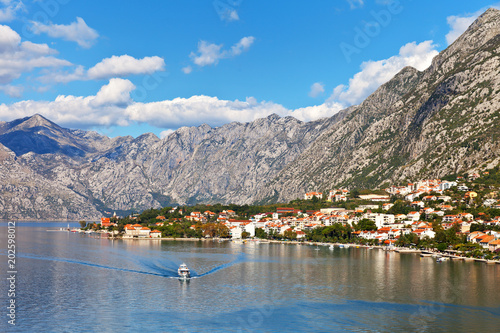 Montenegro. Kotor Bay. A picturesque view from the water to the coastal town of Dobrota, the Institute of Marine Biology and the old small church of St. Ilijah