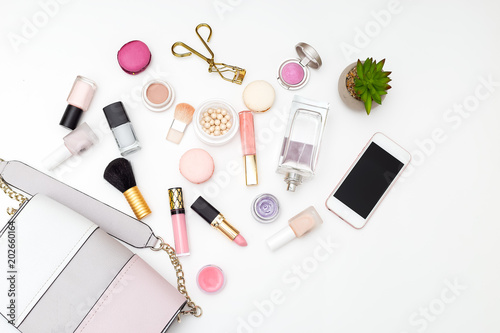 Woman's swimsuit and cosmetics set on a white background. Flat lay