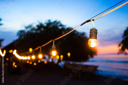 Beach promenade at sunset with party lights