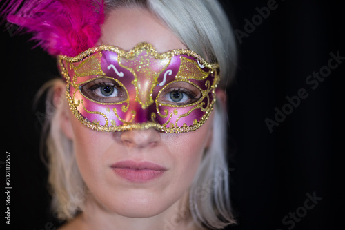 Woman wearing masquerade mask 