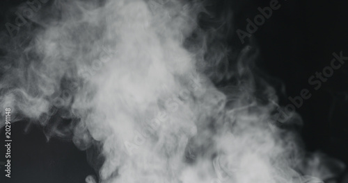 vapor steam rising over black background