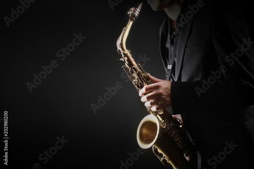 Saxophone player. Saxophonist hands playing saxophone