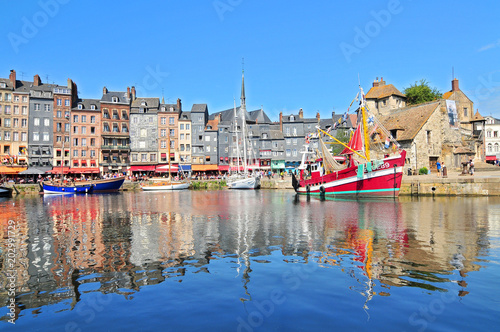Honfleur harbour in Normandy France. Color houses and their reflection in water.