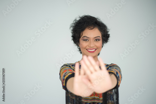 woman showing her hand cover her face on white background