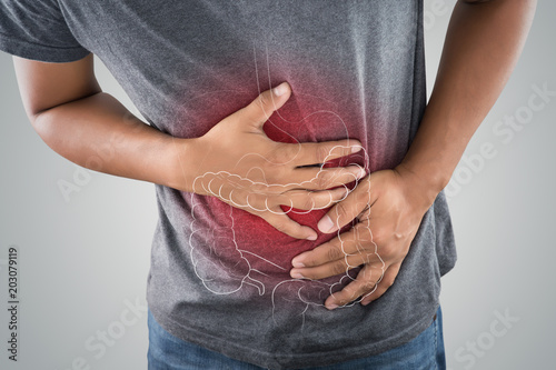 The photo of large intestine is on the man's body against gray background, People With Stomach ache problem concept, Male anatomy