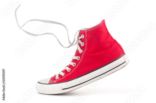 Single red sneaker on white background