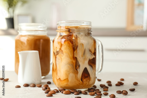 Mason jar with cold brew coffee on table