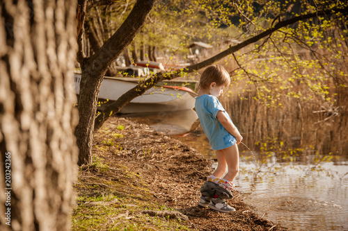 blond child pee in the lake