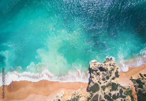 Aerial view of sandy beach and ocean with beautiful clear turquoise water. 