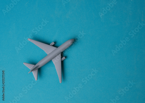 Gray Miniature toy airplane on blue background