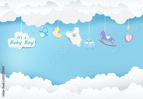 Paper art of cloud with toy shower on blue sky paper cut style, baby boy card illustration