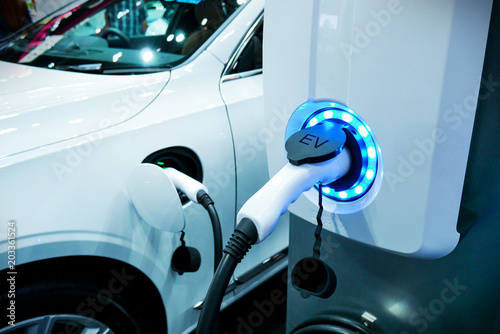 Power supply connect to electric vehicle for charge to the battery. Charging technology industry transport which are the futuristic of the Automobile.EV fuel Plug in hybrid car.