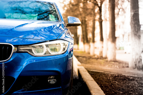 luxury blue car front view. sunlight