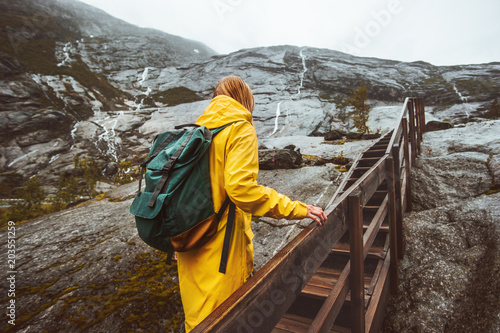 Traveler woman climbing up stairs in rocky mountains solo Traveling adventure Lifestyle active vacations in Norway