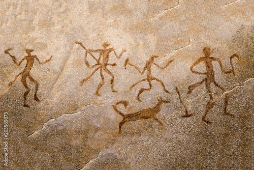 image of ancient hunters with a dog on the wall of the cave. ancient art, history, archeology