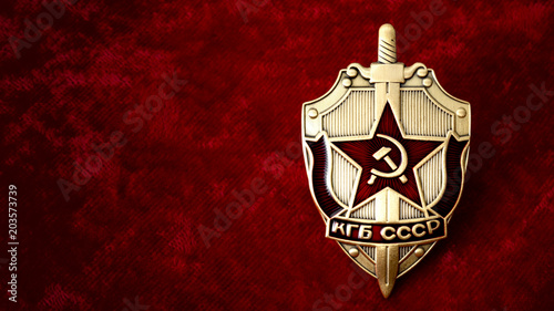Secret service, intelligence agency, and espionage concept with cold war era KGB badge from the former USSR, on red background with copy space