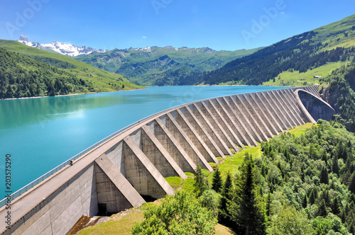 lake and concrete foothill of a dam in mountain 