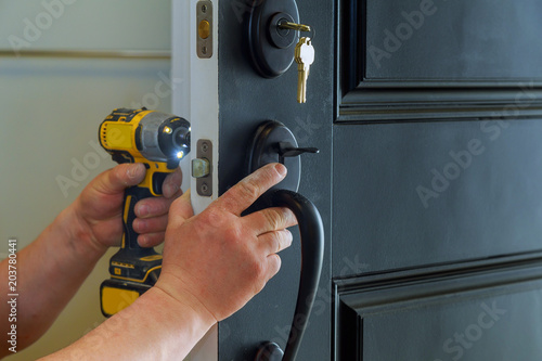 house exterior door with the inside internal parts of the lock visible of a professional locksmith installing or repairing a new deadbolt lock