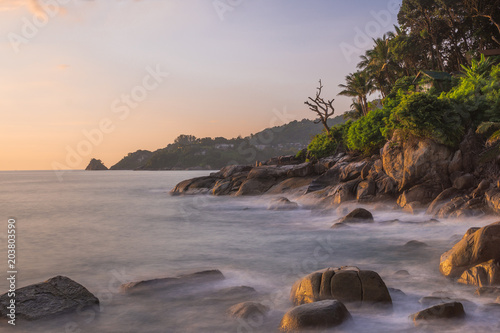 Kalim beach in Patong, Phuket, Thailand. Rock beach with strong wave, long exposure make it harmonic view. Capture this in the evening.