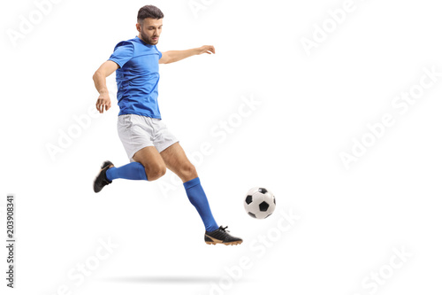 Soccer player in mid-air kicking a football