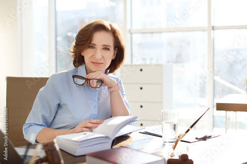 Female lawyer working at table in office