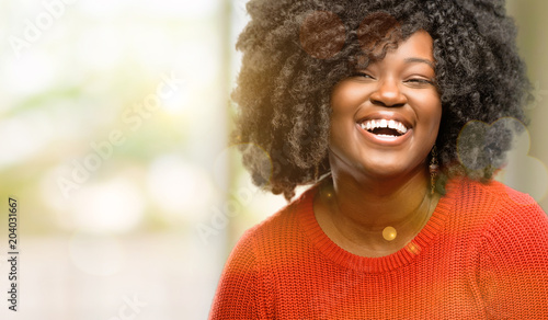 Beautiful african woman confident and happy with a big natural smile laughing, outdoor