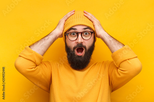 Bearded puzzled hipster in glasses