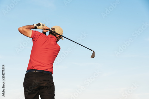 Golfist playing on golf course.