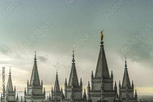 The Angel Moroni and spires of Salt Lake Temple on an overcast spring evening. The Church of Jesus Christ of Latter-day Saints, Temple Square, Salt Lake City, Utah, USA.