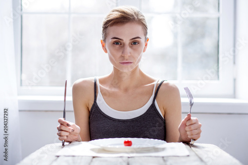 Fashion show. Cheerless young woman losing weight while preparing for the show