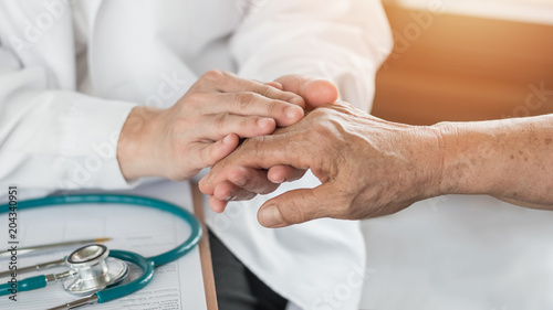 Elderly senior adult patient (older person) having geriatric doctor consulting and diagnostic examining on aging and mental health care in medical clinic office or hospital examination room