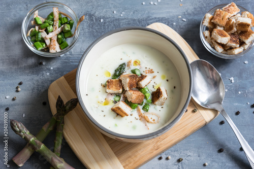 Delicious asparagus soup with bacon, fried asparagus and homemade pastries