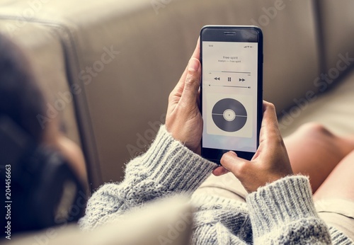 Woman listening to music through the phone