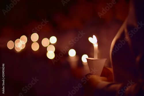 The nurse is showing the power of candlelight to commemorate those who have valued the past.