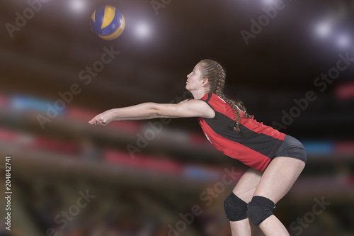 Female professional volleyball player on volleyball court