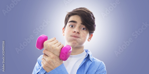 portrait of teenager lifting weight with effort