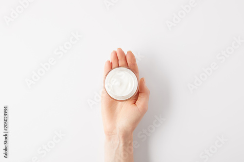 cropped image of woman holding organic cream in container