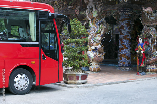 Red bus for tourists near Pagoda in Dalat,Vietnam. Da Lat is a popular tourist destination of Asia.